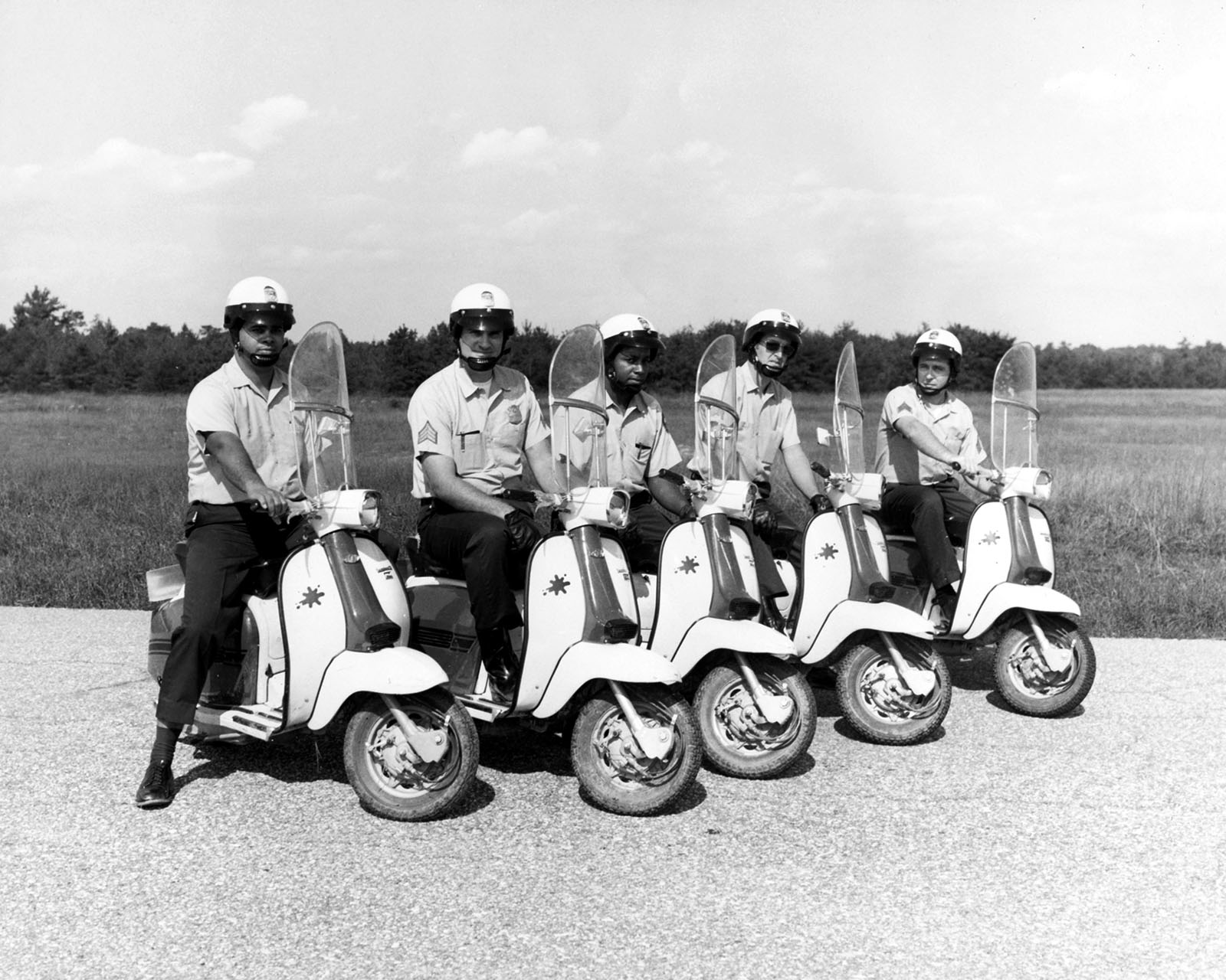 Members of the Uniformed Division line up on motorscooters.