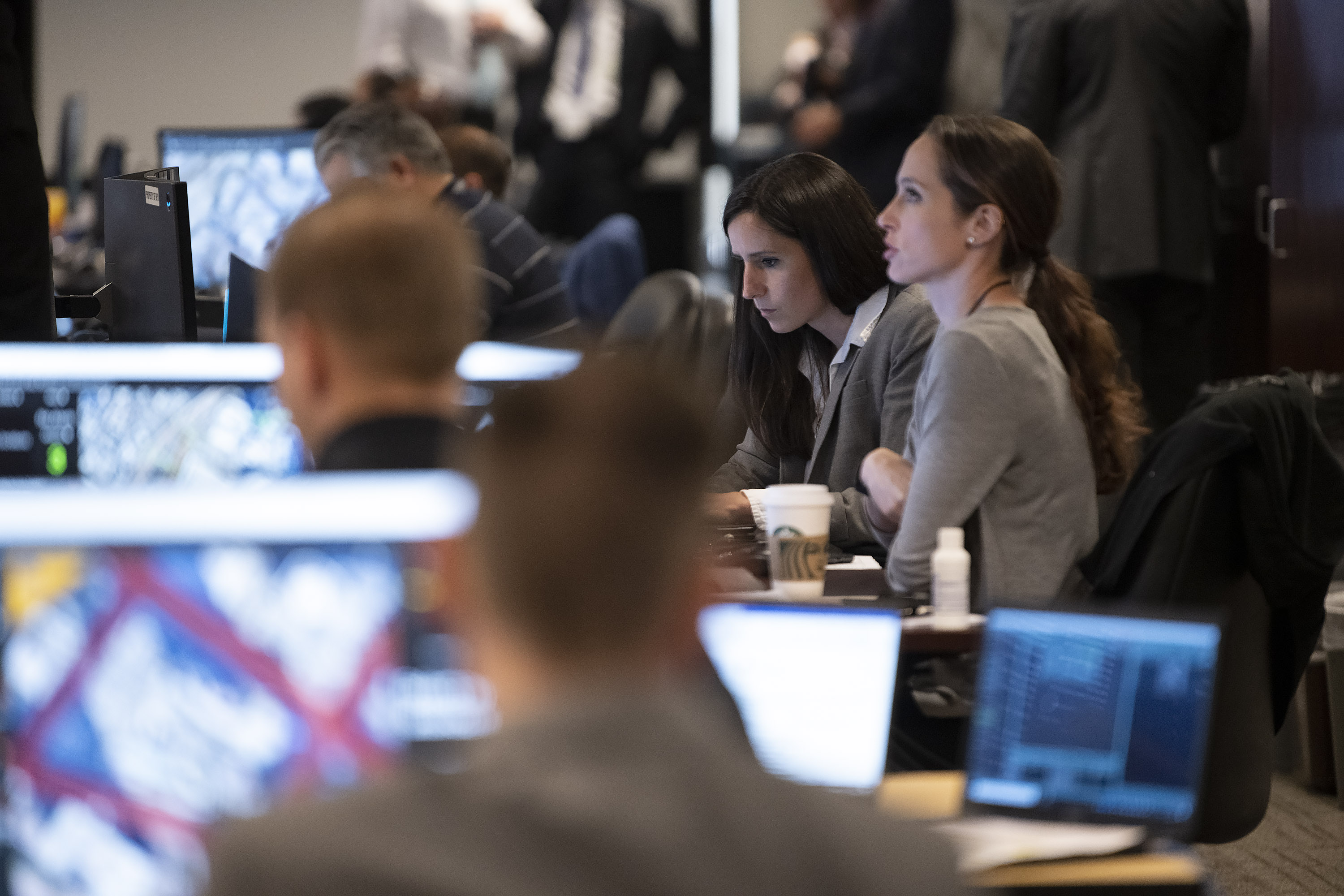 Secret Service personnel working on computers, monitoring protective operations.