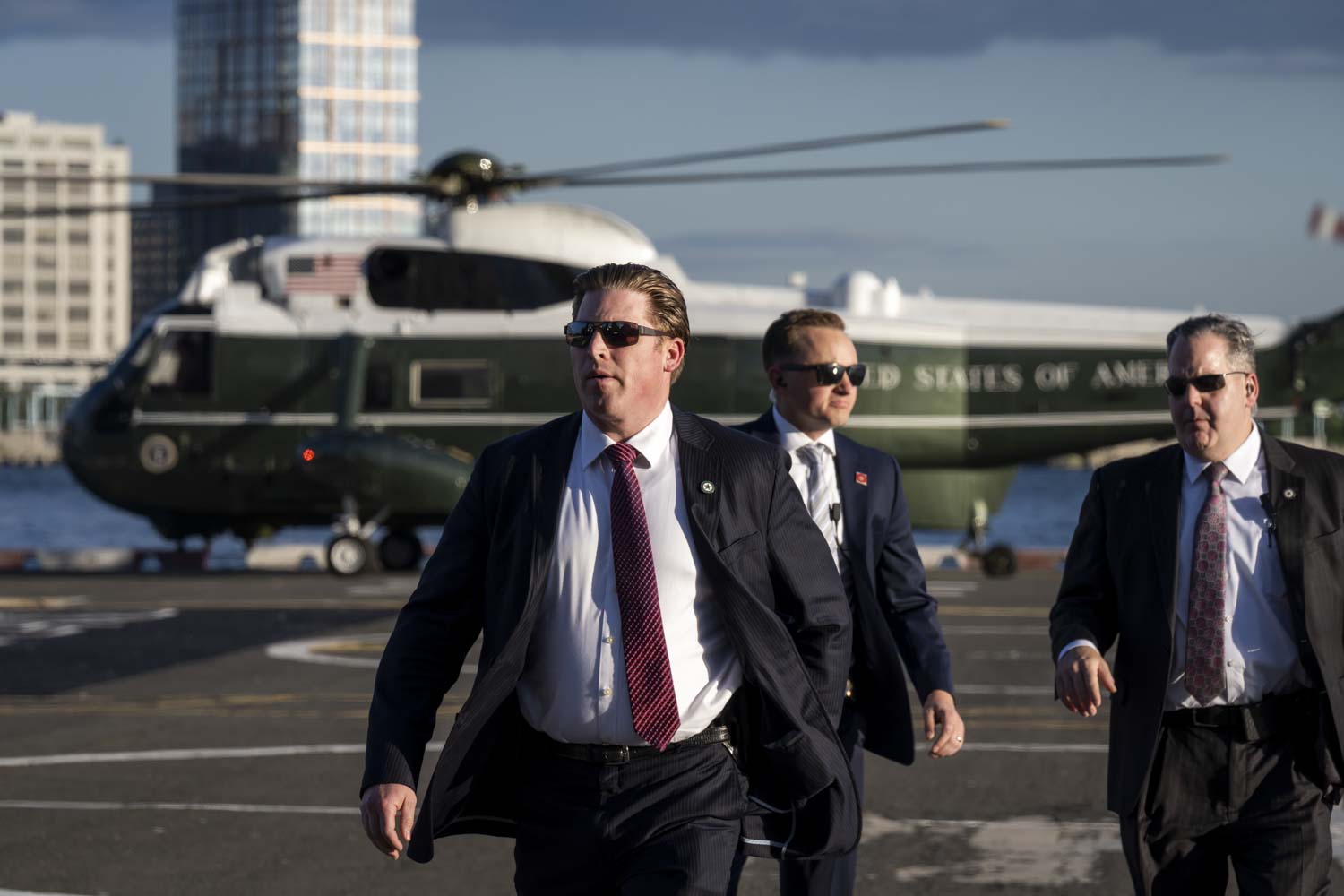 Three Special Agents standing outside the Marine One helicopter in New York City.