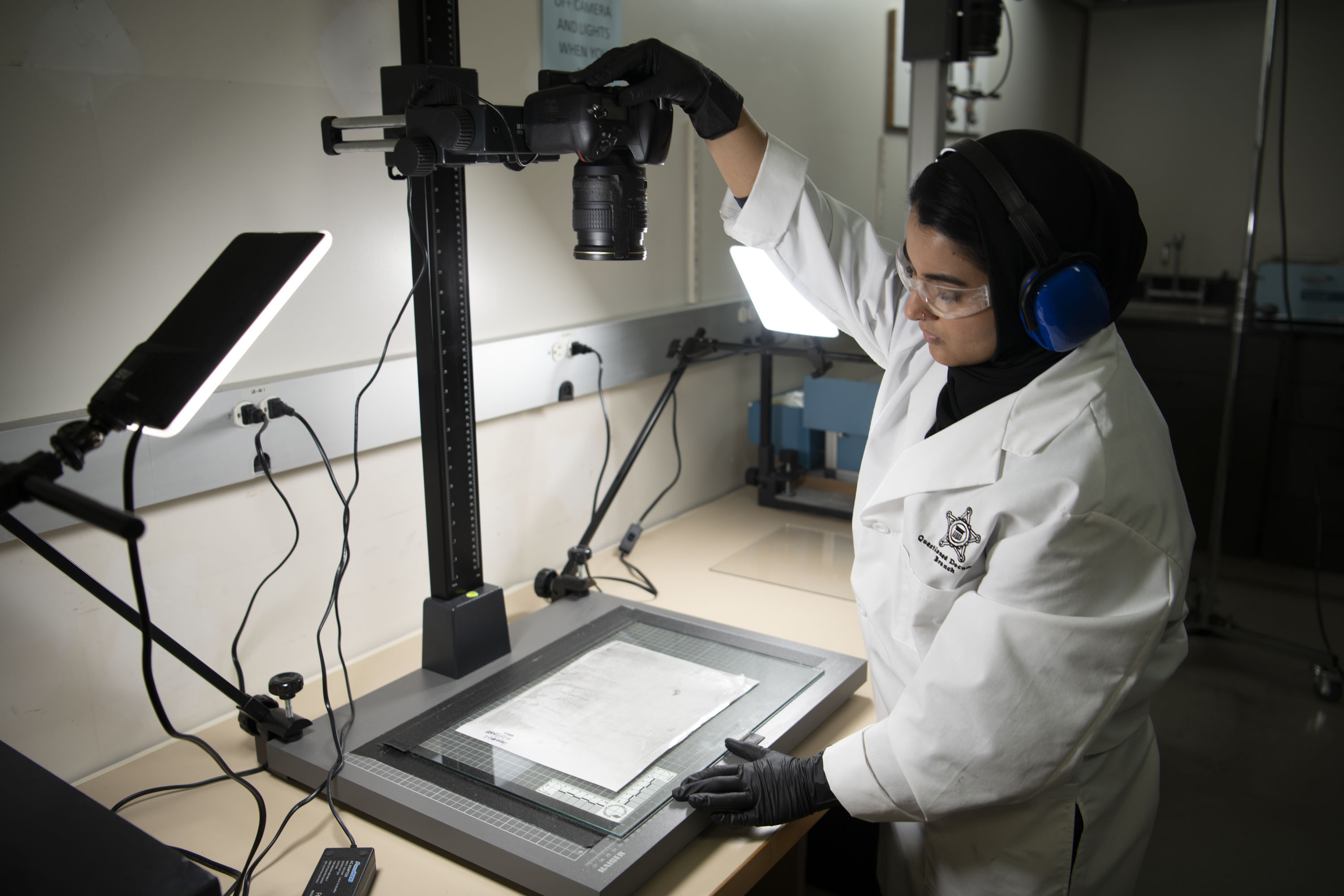 A lab specialist examines a document.