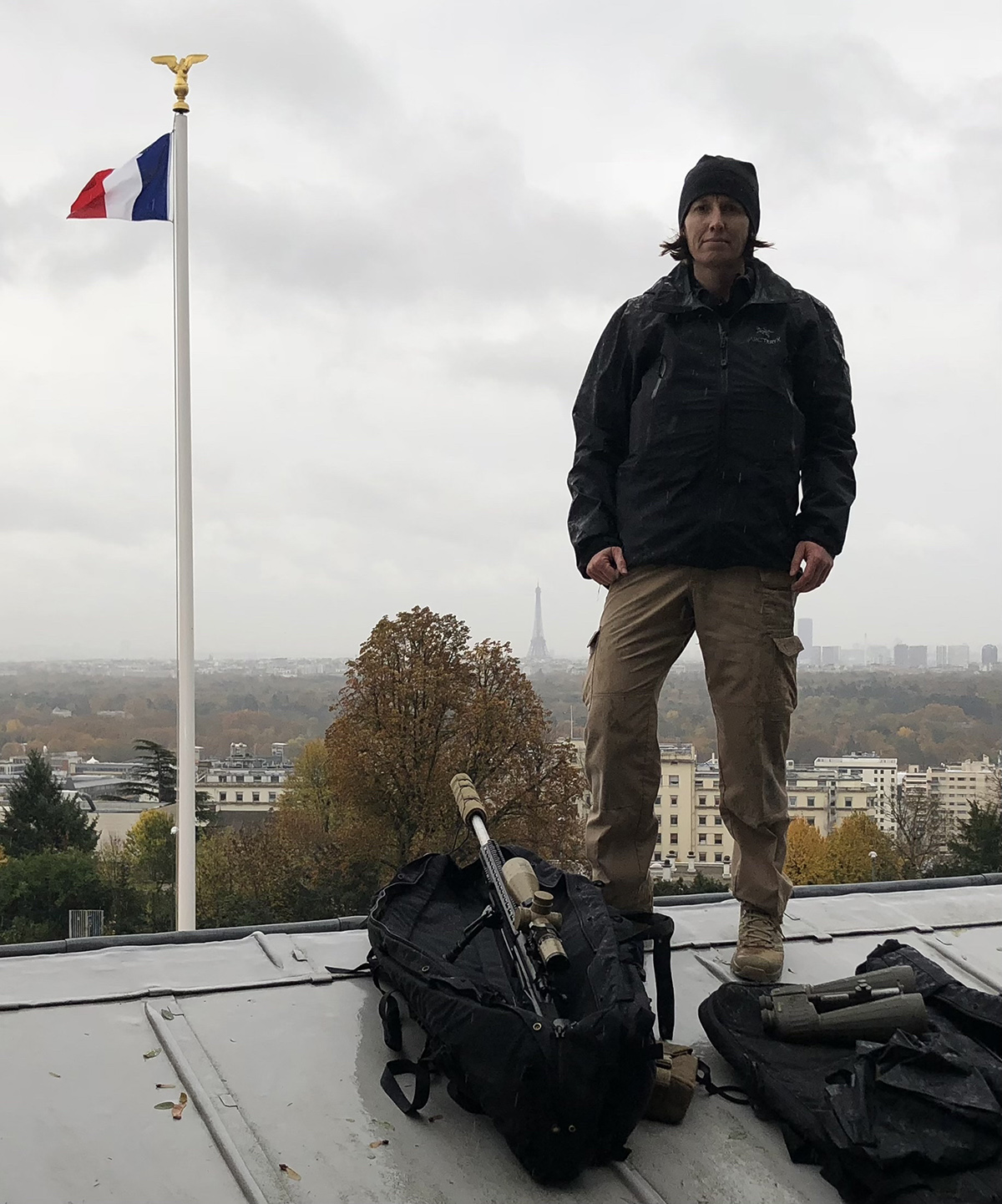 Officer-Technician Kim Sayles on the rooftop of a building in Paris with counter sniper gear.