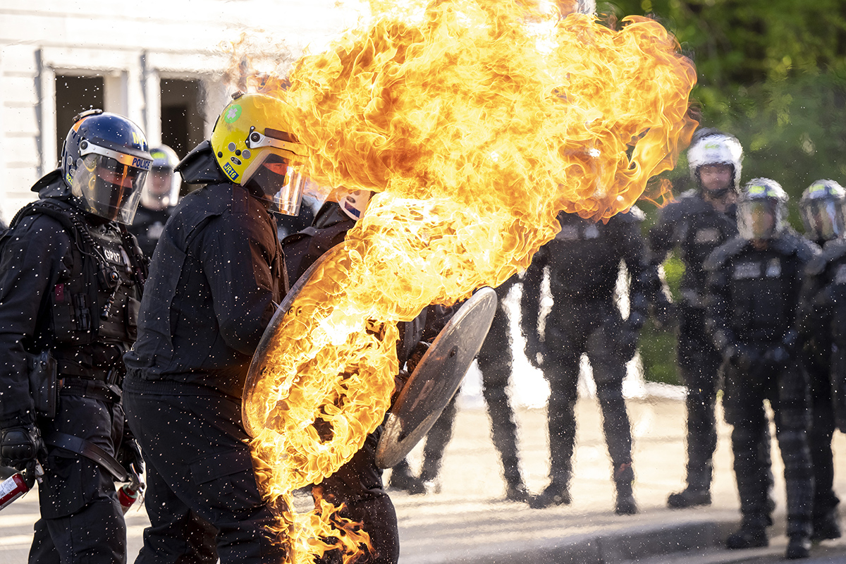 Officers repel fire with their shields during a training exercise.