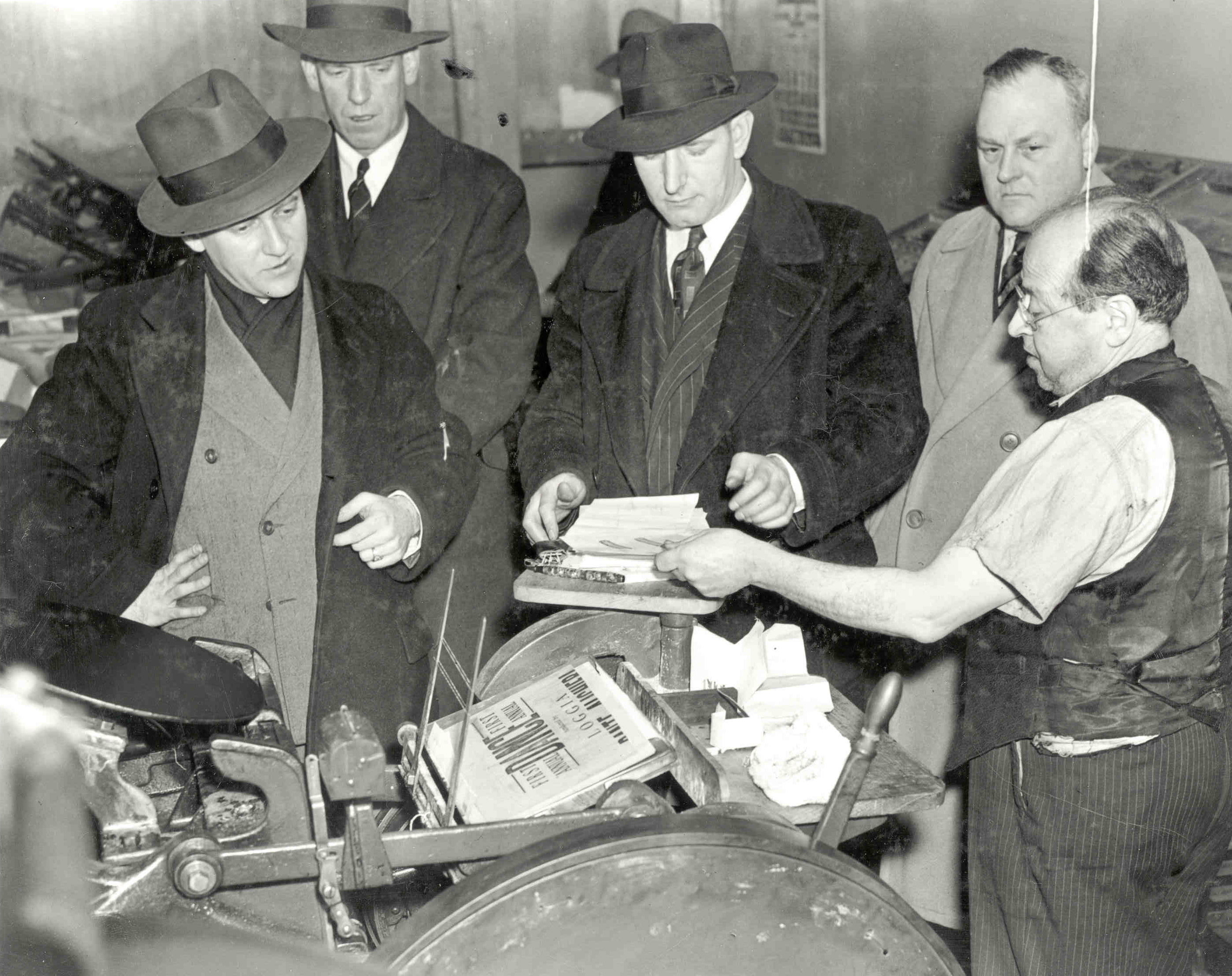 Special Agents examine evidence during a raid in 1943.