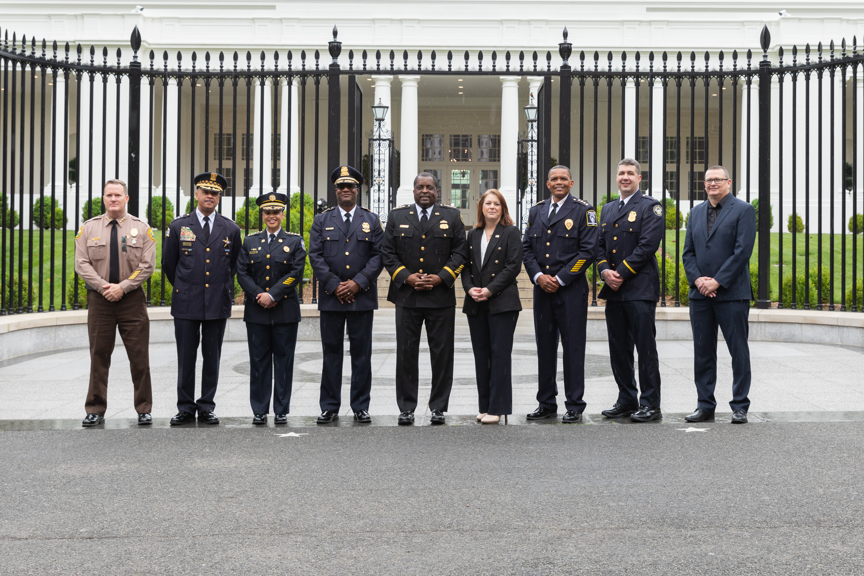 Police in dress uniforms standing in front of the White House
