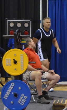 Senior Special Agent Jarett Makara (standing) approaches the bench press during the 2015 World Police and Fire Games in Fairfax, VA.