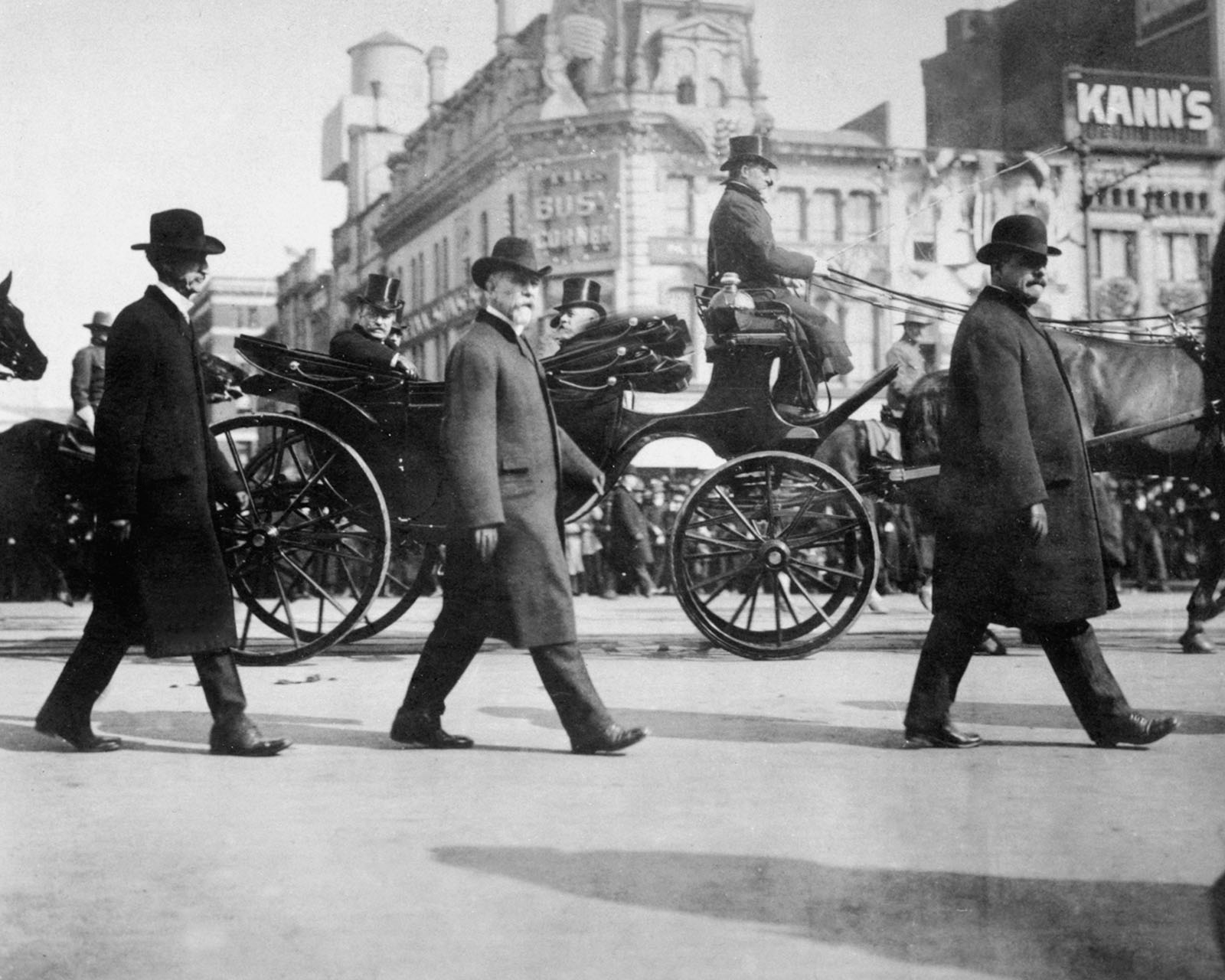 Secret Service operatives surround President Theodore Roosevelt in a protective detail.