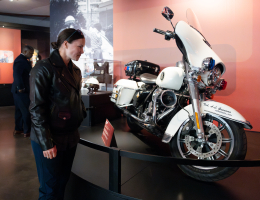 Officer Lauren Gunawan examines the Secret Service exhibit at the Harley-Davidson Museum featuring a bike she has ridden as part of the Secret Service Motorcade Support Unit.