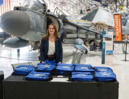 Domestic Security Strategist Courtney Tassin, of National Threat Assessment Center, hands out Secret Service merchandise at the Violence Prevention Symposium.